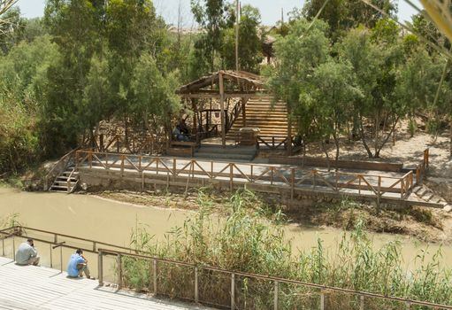 Qasr el Yahud,ISrael,25-,may-2010: people sitting at the Baptismal site Qasr el Yahud on the Jordan river is according to the bible the place where Jesus Christ is being baptized by John the baptist