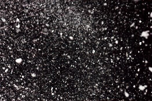 white snow falls on the black sky. Snowstorm on a black background. In isolation. heavy snowfall.  drifts. severe winter.the texture is heavy snowfall on a black background