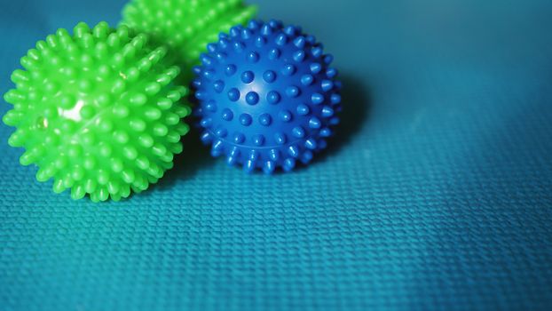 Massage ball and roller for self massage, reflexology and myofascial release, blue background. Equipment for sports, yoga, fitness