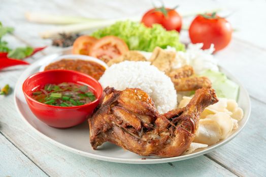 Nasi lemak kukus with fried drumstick, popular traditional Malaysian local food.