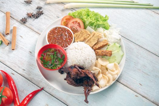 Nasi lemak kukus with quail meat, popular traditional Malaysian local food. Flat lay top down overhead view.