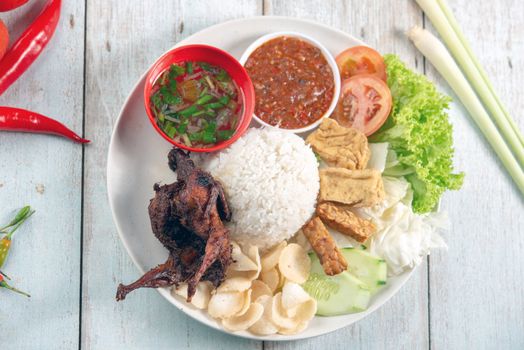Nasi lemak kukus with quail meat, popular traditional Malaysian local food. Flat lay top down overhead view.
