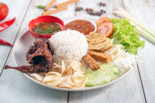 Nasi lemak kukus with quail meat, popular traditional Malaysian local food.