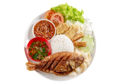 Fried tilapia fish and rice, popular traditional Malay or Indonesian local food. Isolated on white background. Flat lay top down overhead view.