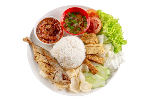 Fried mackerel fish rice with sambal, popular traditional Malay or Indonesian local food. Isolated on white background. Flat lay top down overhead view.