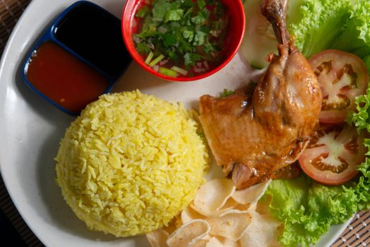 Chicken rice with drumstick, popular traditional Malaysian local food. Flat lay top down overhead view.