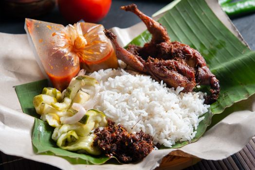Nasi lemak kukus with quail, popular traditional Malay local food.
