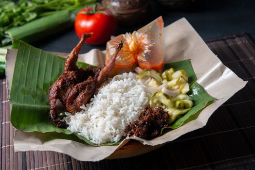 Nasi lemak kukus with quail, popular traditional Malay local food.