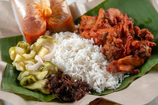 Nasi kukus ayam berempah, popular traditional Malay local food.