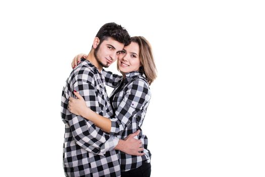 Young couple in skirts hugging isolated on white