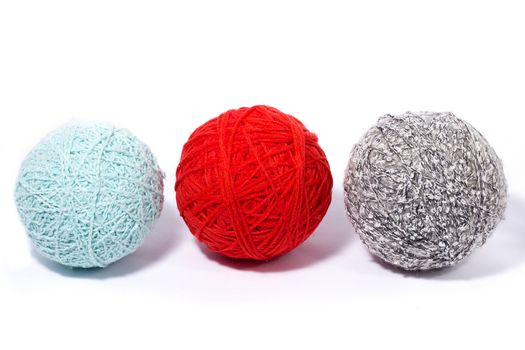 a set of balls of thread for knitting, isolate, homemade needlework, three multi-colored skeins of wool yarn