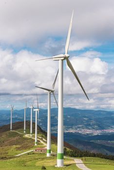 Renewable energy. Wind turbines, eolic park in scenic landscape of basque country, Spain.