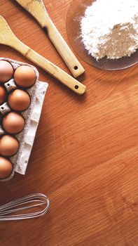 Ingredients and utensils for baking on a pastel wooden background, top view. Concept of kitchen, cooking and Easter