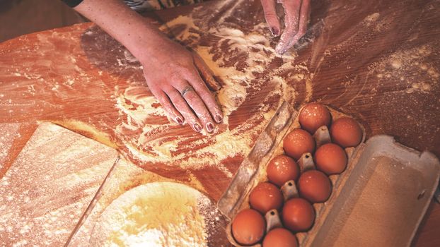 Close up scene of female hands making dough. Soft focus, kitchen, cooking ingredients