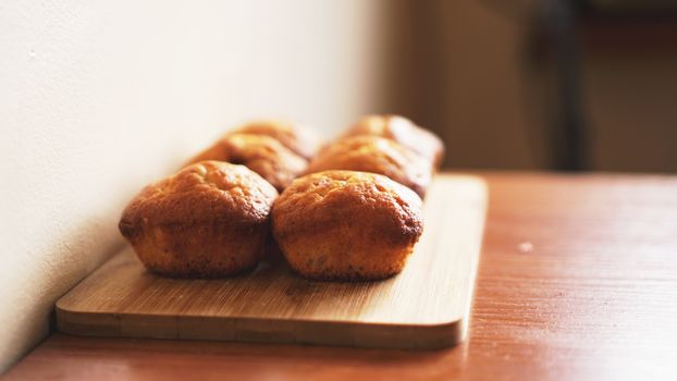 Six delicious home-made muffins on a wooden background. Dessert for gourmet. Selective focus