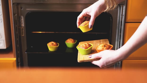 Close-up muffins ready to get out of electric oven. Concept of cooking home cake. Tasty food.