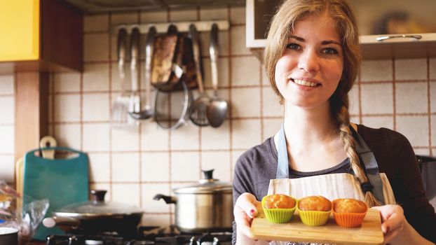 Homemade caramel muffins in a baking dish in the hands of the confectioner. Dessert for gourmet. Selective focus