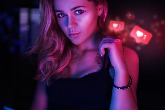 Lucky charming woman of 23 years with signs in form of like from social network - Sexy girl in neon red and blue light
