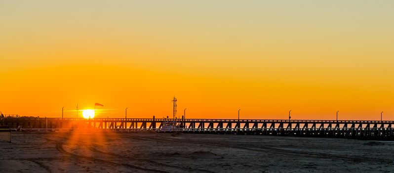 long pier at sunset on the beach of Blankenberge, Belgium, sunset with a colorful sky