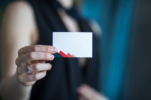 Female hand holding a blank business card