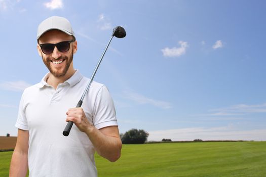 Portrait of male golfer with golf club at course