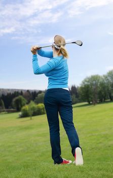 Caucasian female golfer hit a golf ball by golf-club driver