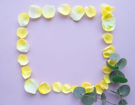 Flower frame with rose petals on pastel pink background. Flat lay, Valentine background.