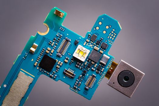 blue circuit board from smartphone with camera next to sim card slot