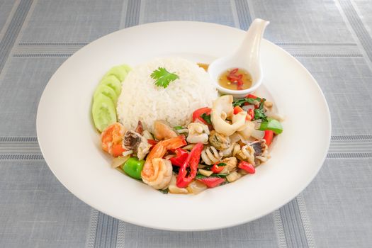 Mixed Seafood fried with chili and vegetables Served with steamed rice on dish