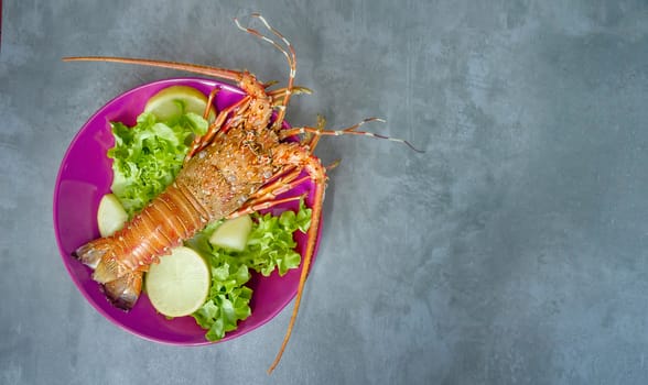 Top view of steamed lobster with fresh vegetable on plate