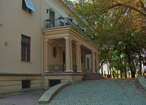 Outside view on entrance into villa with doors, stairs and windows