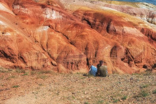 Relaxing man and woman in Valley of Mars landscapes in the Altai Mountains, Kyzyl Chin, Siberia, Russia