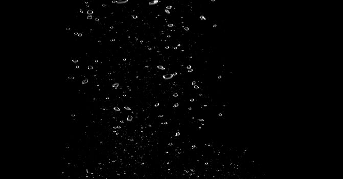 Blurry images of soda liquid water bubbles or carbonate drink or oil shape or beer fizzing or splashing and floating drop in black background for represent sparkling and refreshing