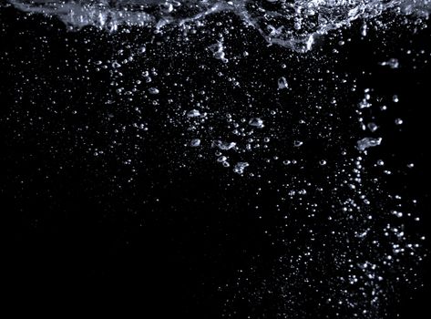 Blurry images of soda liquid water bubbles or carbonate drink or oil shape or beer fizzing or splashing and floating drop in black background for represent sparkling and refreshing