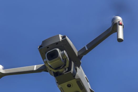 drone flying overhead against blue sky