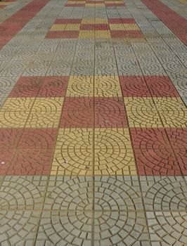 Tiled mosaic concrete pavement of the sidewalk
