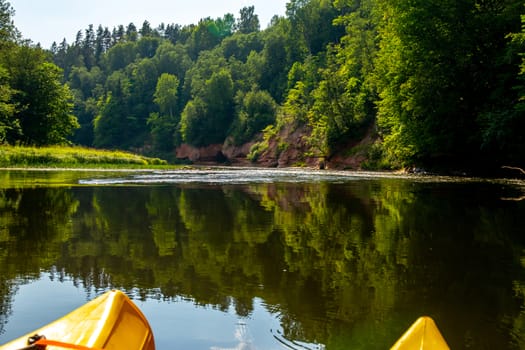Kayak and canoe ride in river Gauja in Latvia. Boat ride by the river. Beautiful view of river from boat. The Gauja is the longest river in Latvia, which is located only in the territory of Latvia. Length - 452 km.

