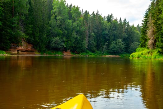 Kayak and canoe ride in river Gauja in Latvia. Boat ride by the river. Beautiful view of river from boat. The Gauja is the longest river in Latvia, which is located only in the territory of Latvia. Length - 452 km.

