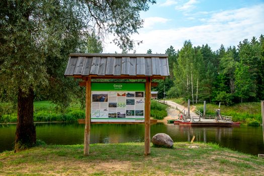 Ligatne ferry crossing on the bank of river Gauja. Ferry across river in Latvia. The ferry over Gauja river is the only crossing of this type in the Baltic States. Ferry is made of two boats fastened together on which there is a plank layer.

