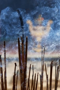 Burning incence sticks in a Buddhist temple