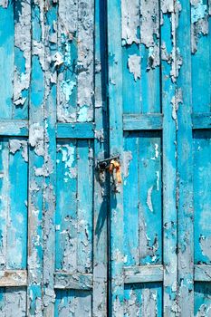 Detail of Old shabby blue wooden door background