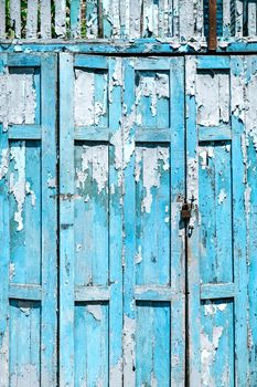 Detail of Old shabby blue wooden door background