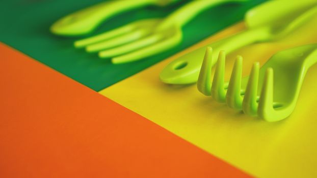 Set of green garden tools on green and yellow background - soft focus