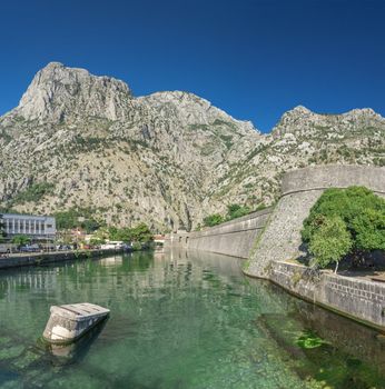 Kotor, Montenegro - 07.11.2018. Massive walls of the fortification Bastion Riva by the river Shkurda in Kotor Old Town in a sunny summer day