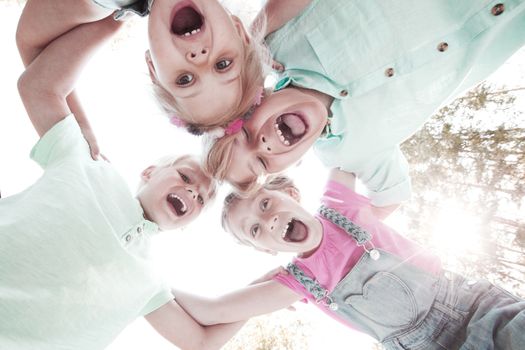 Group of smiling children looking down into camera