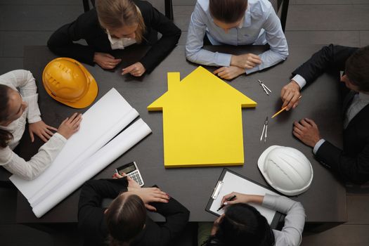 Top view of people around table in construction business meeting