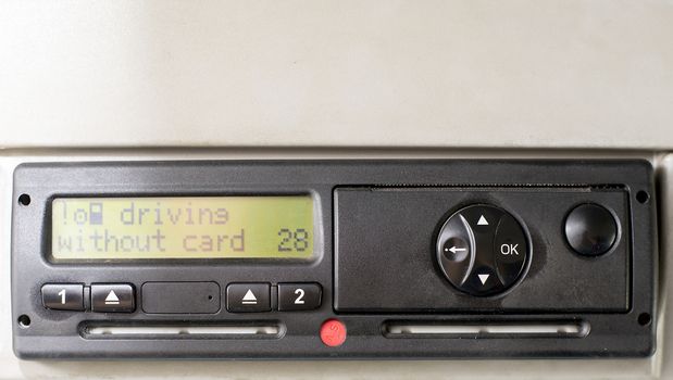 Digital tachograph display reads DRIVING WITHOUT CARD. No inserted card in the device. Insert the drivers card. No personal data.