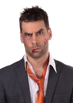 Close up of a businessman with bloody lip, beaten and bruised, isolated