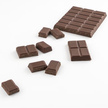a chocolate bar chopped on a white surface
