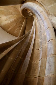 Spiral stone stair in old medieval tower, diminishing perspective, low angle view